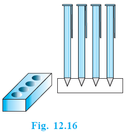 Pen stand with conical depressions.